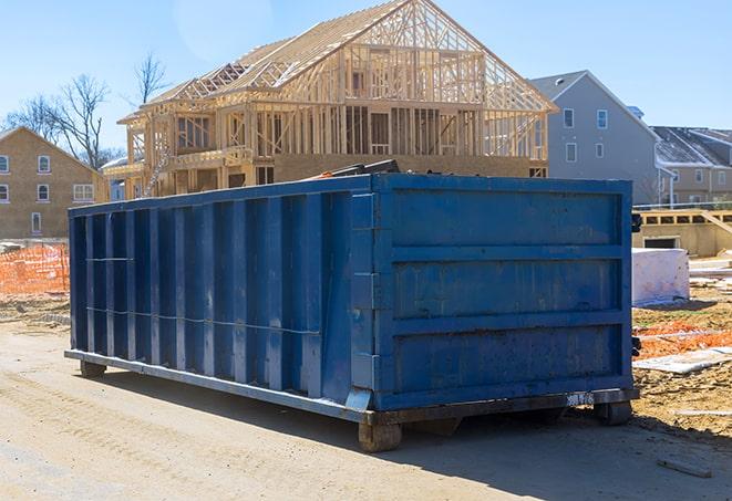 a single garbage dumpster sitting in an industrial area